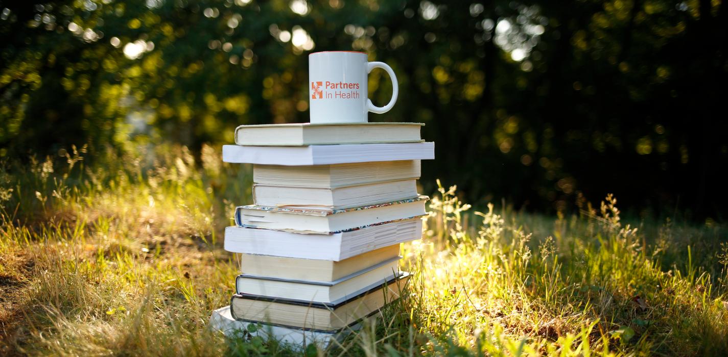 10 books stacked below a mug.