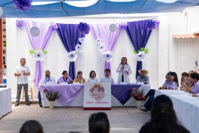 The opening ceremony for the new Casa Materna, where Valeria Macías (fourth from left), executive director of Compañeros En Salud, sits on a panel.