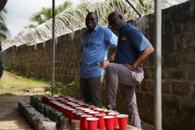 In Liberia, Dr. Sterman Toussaint shows crops to Dr. Wesler Lambert, Zanmi Lastane's executive director.