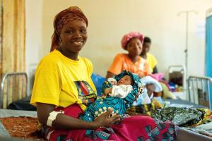 Kumba Sandy holds her newborn baby boy on the day they are being discharged to go home after giving birth.