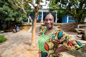 Midwife stands outside of clinic in Sierra Leone