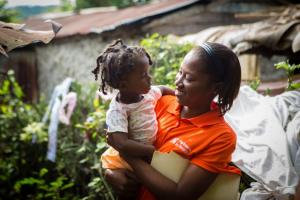 Nurse holds baby in Haiti