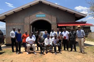Mark Brender, PIH Canada's National Director, and Tilak Acharya, Director of Finance and Administration, pose for a photo with the Malawi team.