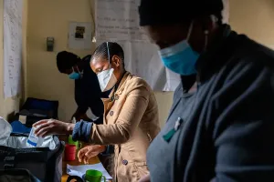 Treatment supporter 'Marealeboha Leoma (center) prepares medications for patients.