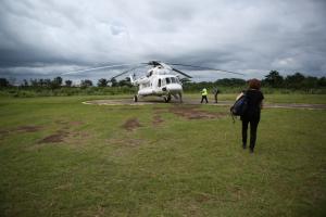 Dr. Sheila Davis walks to helicopter in Liberia