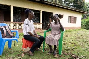 Naewah T. Bemian (left), a member of PIH Liberia's community health team, during a follow-up visit with Patience N. Toe.