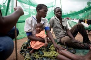 Ruth Lazo sleeps outside at Somo camp with Piriran Seza and their 4-month-old daughter, Alufa Lazo. PIH provides clinical care for Cyclone Freddy survivors.