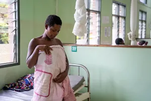 Jeremana Mula practices kangaroo mother care, utilizing skin-to-skin contact with her newborn, Iyad Gobodo, in the maternal ward at Neno District Hospital in Malawi. 