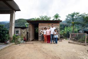 Ariadna stands with her family in their home in Plan de la Libertad in Chiapas, Mexico. Photo by Masao Yanome for PIH.