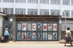 Pedestrians pass the entrance to Princess Christian Maternity Hospital in Freetown, Sierra Leone