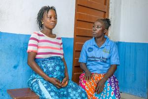 Gladys Abu, a traditional birth attendant, right, accompanies   expecting mother Mary Senesie to Bumpe Community Health Post for an appointment.