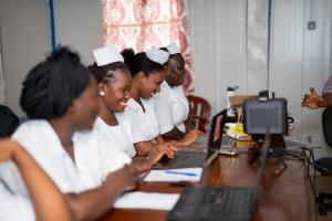 From left to right, Gladyse A. Kanu, Isata Bah, and Francess Kamara participate in an Electronic Medical Records (EMR) training at a maternity facility.