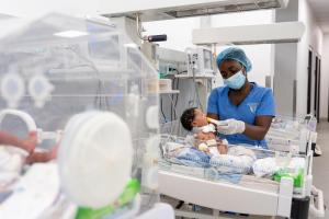 Daniella Jabati, state registered nurse feeds a newborn in the inborn ward of the neonatal intensive care unit at the MCOE.