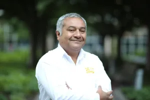Doctor standing in white lab coat with arms crossed