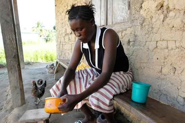 Single mother preparing food in Sierra Leone