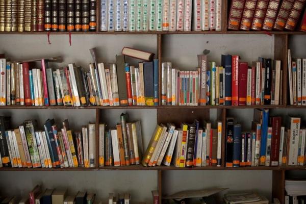 Books line the wall of a PIH facility in Cange, Haiti.