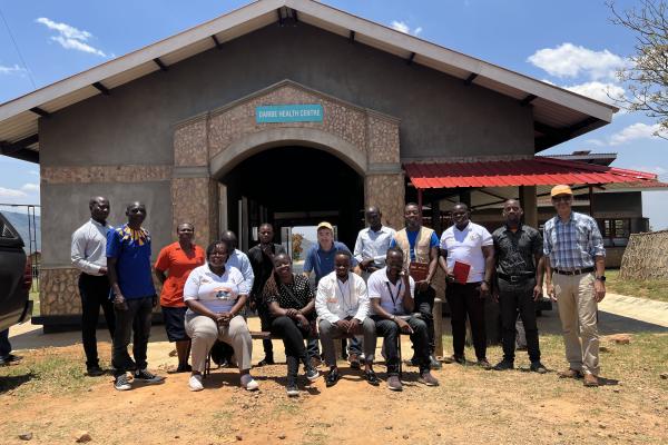Mark Brender, PIH Canada's National Director, and Tilak Acharya, Director of Finance and Administration, pose for a photo with the Malawi team.