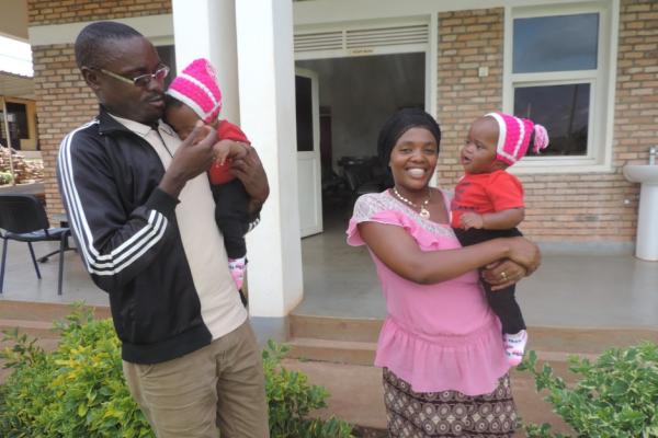 Parents play with daughters in Rwanda