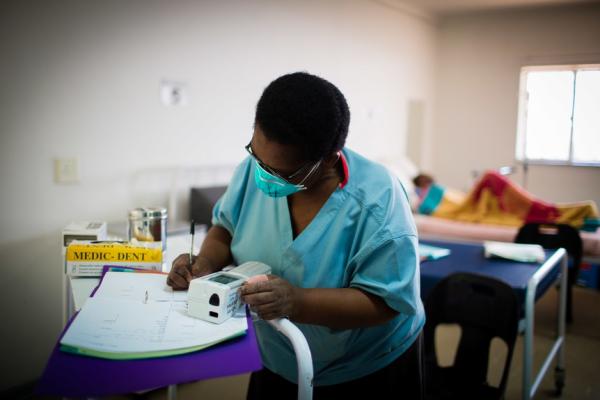 Nurse records patient information in MDR-TB ward in Lesotho