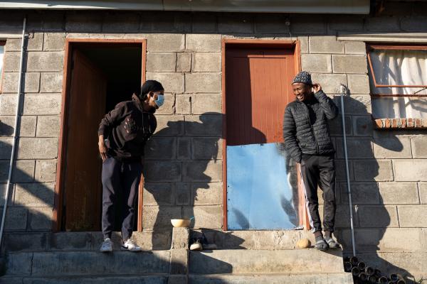 Sefonthoane Mohohla, 26, with his friend and neighbor, Kaemane Makhetha, who is his treatment supporter.