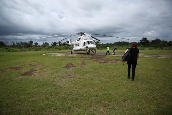 Dr. Sheila Davis walks to helicopter in Liberia