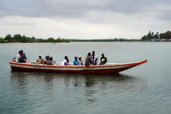 Residents of Puluken cross the Hoffman River on the Puluken Town Canoe in July 2024.