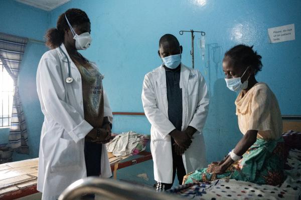 Physician Assistants Theophilus Dolo and Kadiatu A. Konneh follow up with Hawa John, a tuberculosis patient receiving care at a PIH-supported TB clinic in Monrovia, Liberia.