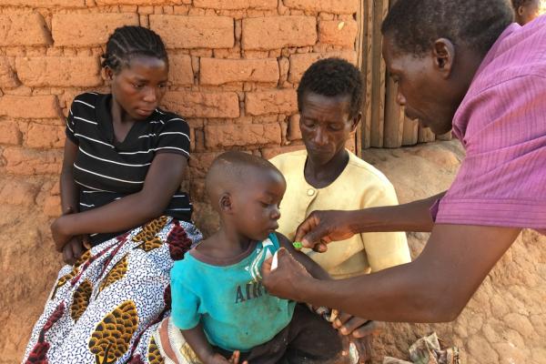 Senior CHW visiting a family in Malawi