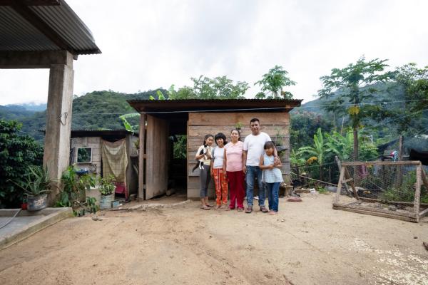 Ariadna stands with her family in their home in Plan de la Libertad in Chiapas, Mexico. Photo by Masao Yanome for PIH.