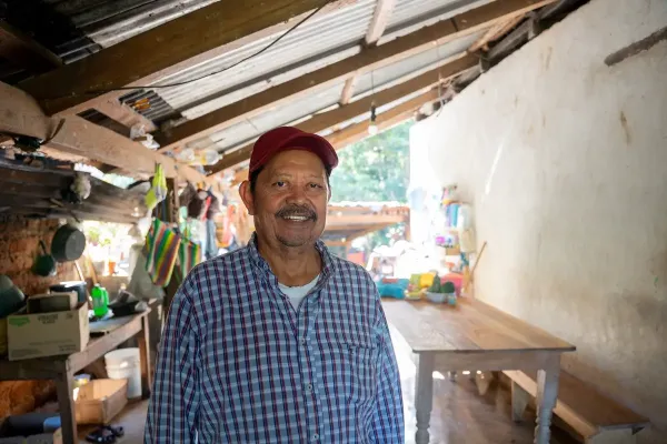 A close-up portrait of Carlos Vasquez, showing his face in detail with a smile. 