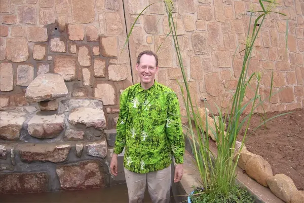 The late Dr. Paul Farmer at the beginning of what will become a flourishing garden in Rwinkwavu, Rwanda.