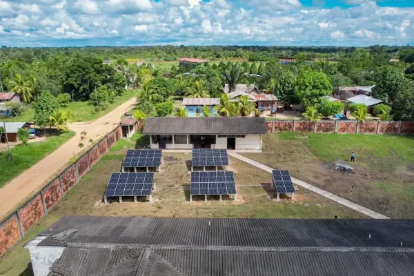 Image of 5 large solar panels in a rural village in Peru