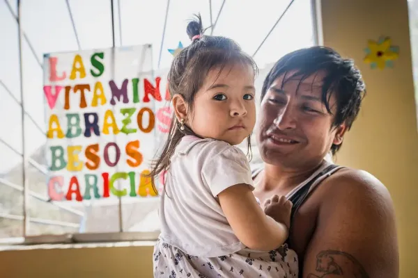 A father holds his daughter. 