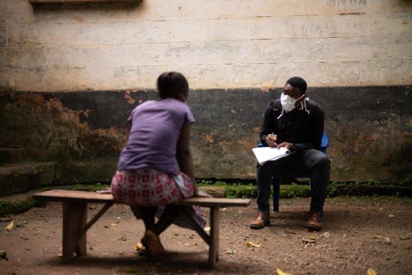 As part of COVID-19 screening and education efforts, a community health worker meets with a patient in Sierra Leone.