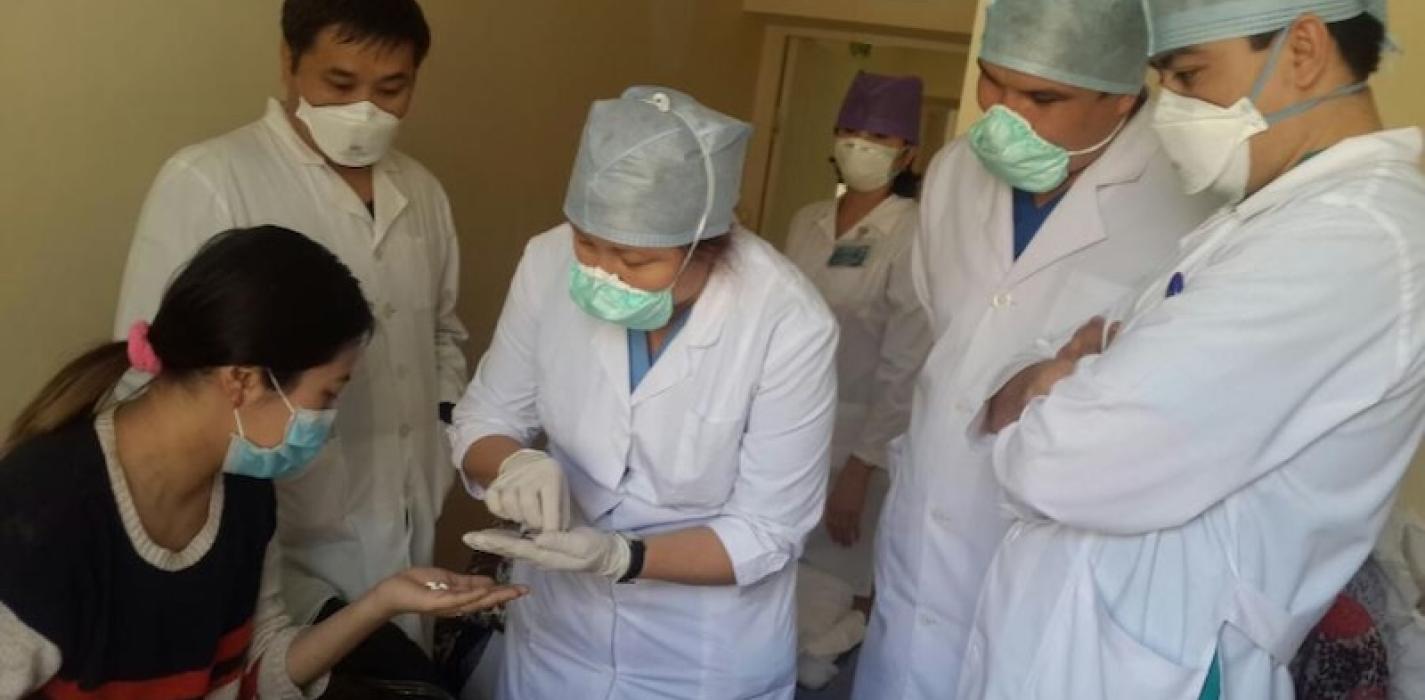 Dr. Yerkebulan Algozhin, endTB/Kazakhstan Team Leader, observes as the first patient takes a dose of new TB drugs in Kazakhstan.