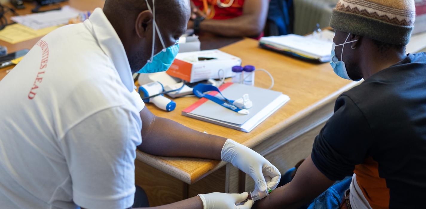 PIH nurse Seabata Ntsibane administers treatment to MDR-TB patient Khamokha Khamokha.