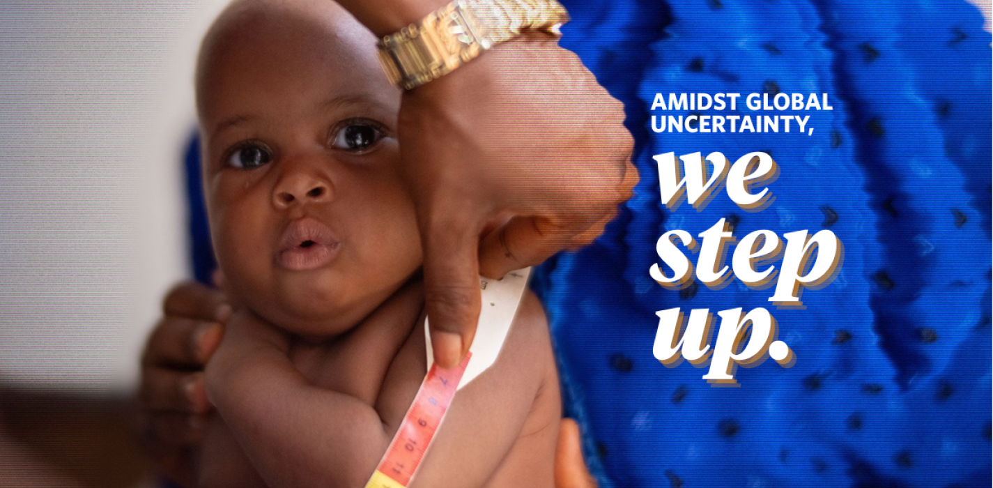 Fatmata Jakite holds her baby at Wellbody Clinic while a nurse does a MUAC test.