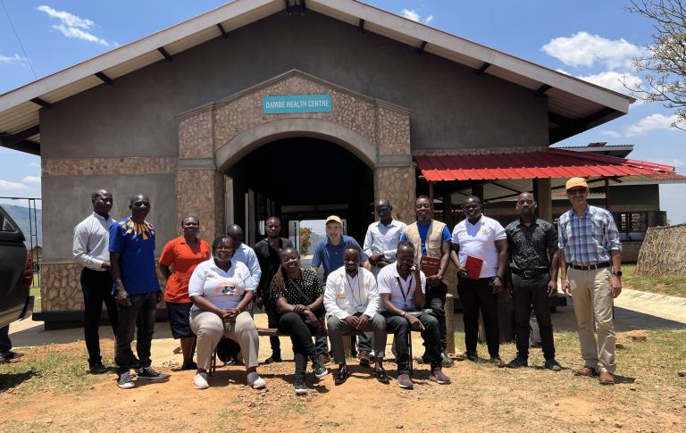 Mark Brender, PIH Canada's National Director, and Tilak Acharya, Director of Finance and Administration, pose for a photo with the Malawi team.