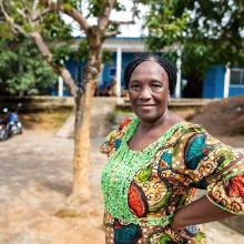 Midwife stands outside of clinic in Sierra Leone