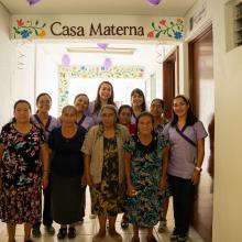 Compañeros En Salud staff stand with traditional midwives in the new Casa Materna