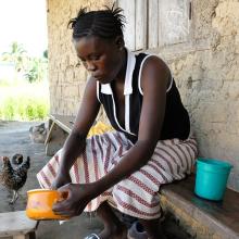 Single mother preparing food in Sierra Leone