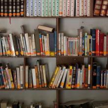 Books line the wall of a PIH facility in Cange, Haiti.