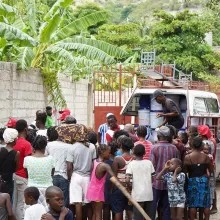 Emergency workers distribute supplies to a crowd in Saint-Marc, Haiti. 