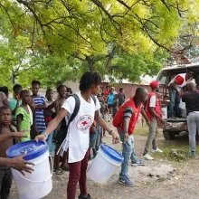 Staff at Saint-Nicholas Hospital, in partnership with UNICEF and the Red Cross, distribute kits outside.