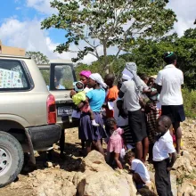 Residents of Jeannin in the area of St. Marc line up for food assistance from a Zanmi Lasante mobile clinic in Haiti. 