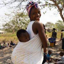 Mother with child on her back