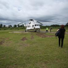 Dr. Sheila Davis walks to helicopter in Liberia