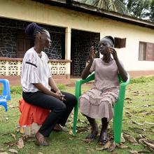 Naewah T. Bemian (left), a member of PIH Liberia's community health team, during a follow-up visit with Patience N. Toe.