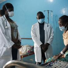 Physician Assistants Theophilus Dolo and Kadiatu A. Konneh follow up with Hawa John, a tuberculosis patient receiving care at a PIH-supported TB clinic in Monrovia, Liberia.