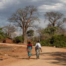 APZU Community Health Worker Grace Mgaiwa (right) walks with Eliza Kazembe (left) during a maternal health home visit near PIH-supported Lisungwi Community Hospital in Neno District, Malawi. Eliza said her health at nine months was good and she was excited to give birth, but joked that it felt like she had been due “forever.” She planned to go to the maternal waiting home at Lisungwi Community Hospital in about a week, to await delivery.